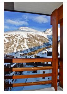 a view of a snow covered mountain from a balcony at Bilocale con vista a Sestriere in Sestriere