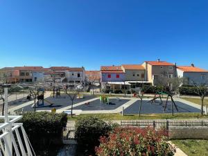 a park with a playground with swings at Apartment Melina in Omišalj