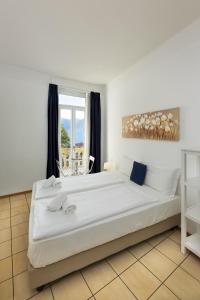 Postel nebo postele na pokoji v ubytování GuestHouse Lugano Center by LR