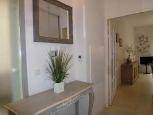 a hallway with a table and a mirror on the wall at Holiday Home Villa Morny by Interhome in Deauville