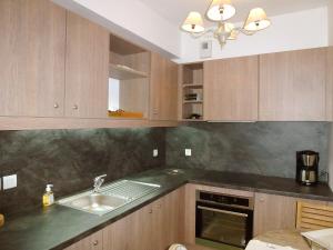 a kitchen with wooden cabinets and a sink at Holiday Home Villa Morny-1 by Interhome in Deauville +13 photos