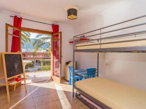 a bedroom with two bunk beds and a balcony at Apartment Sorts de la Mar-1 by Interhome in Denia