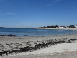 an empty beach with the ocean in the background at Apartment Mer et Soleil by Interhome in Carnac