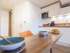 una cocina con una mesa de madera con dos tazones. en Apartment Les Marinas-6 by Interhome, en Deauville 15 fotos más