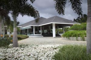 a building with a palm tree and white flowers at The Serai Chickmagalur in Chikmagalūr