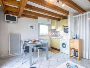 Una cocina con una mesa y sillas en una cocina. en Apartment MEN DU-2 by Interhome, en Carnac