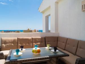 a table with two bowls of fruit on top of a couch at Apartment Alamar by Interhome in La Cala de Mijas