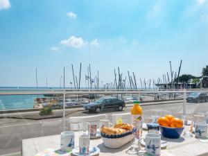 a table with food and a view of a harbor at Apartment Atlantique-2 by Interhome in Carnac
