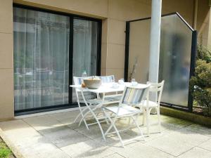 a white table and chairs sitting on a patio at Apartment Nautica by Interhome in Saint Malo