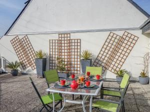 a patio with a table and chairs in a marquee at Apartment Les Embruns-2 by Interhome in Carnac