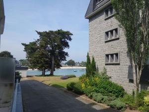 a road next to a building with a view of the water at Apartment Baie de Beaumer-1 by Interhome in Carnac