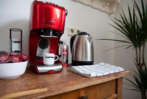 a red coffee maker sitting on top of a wooden counter at 2 BR City Apartment in Neubau, 6 min to city center in Vienna