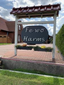 a sign that says fever harms in front of a building at Harms, Ferienwohnung in Südbrookmerland