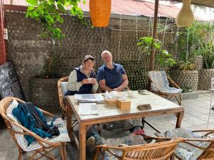 a man and a woman sitting at a table at Hotel Nightingale in Pokhara