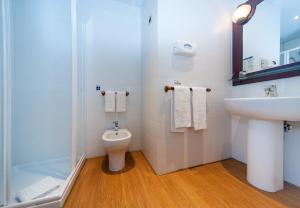a bathroom with a toilet and a sink and a shower at Hotel Bellavista Club-Caroli Hotels in Gallipoli