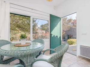 a patio with a glass table and chairs at Holiday Home Mimosa by Interhome in Cadaqués +21 photos