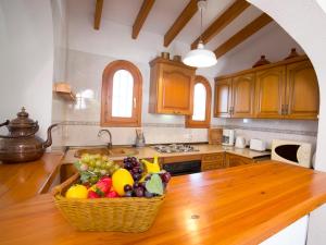 a kitchen with a basket of fruit on a table at Holiday Home Yona by Interhome in Empedrola