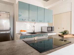 a kitchen with a sink and a microwave at Apartment La Cormorane-3 by Interhome in Carnac