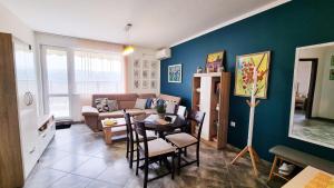 a living room with a couch and a table at The View Veliko Tarnovo in Veliko Tŭrnovo