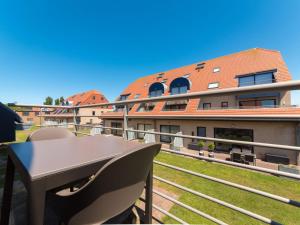 a table and chairs on the balcony of a building at Apartment Tivoli Gardens-4 by Interhome in Mispelburg