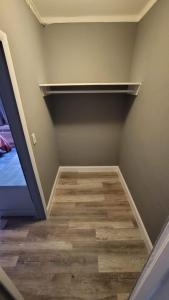 an empty room with a closet with a wooden floor at Travel Inn Fort Pierce in Fort Pierce