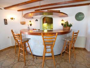 a kitchen with a bar with chairs and a mirror at Apartment Triton 01 in La Canuta