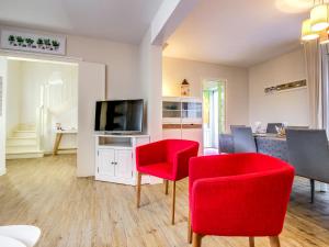 サン・マロにあるHoliday Home La Baie des Corsaires-4 by Interhomeのリビングルーム(赤い椅子、薄型テレビ付)