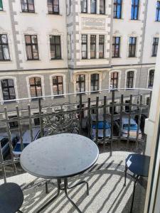 a table and chairs on the balcony of a building at Apartament 11A- Hvile in Toruń
