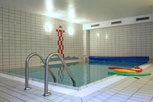a swimming pool with two inflatables in a room at Ferienwohnung Merle in Wyk auf Föhr