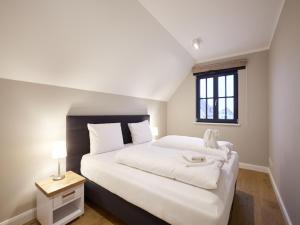 A bed or beds in a room at Reetland am Meer - Superior Reetdachvilla mit 2 Schlafzimmern F16