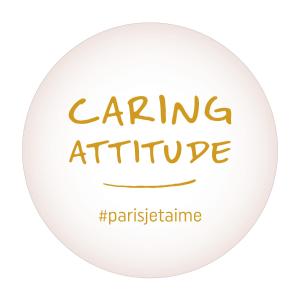 a white circle with the words caring attribute at Hôtel Le Bellechasse Saint-Germain in Paris