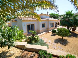 a house with a palm tree in front of it at Holiday Home Casa Kate by Interhome in Calpe