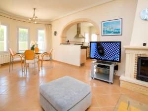 a living room with a television and a dining room at Holiday Home Casa Kate by Interhome in Calpe