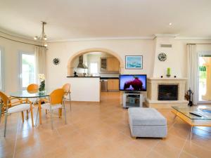 a living room with a table and a tv at Holiday Home Casa Kate by Interhome in Calpe