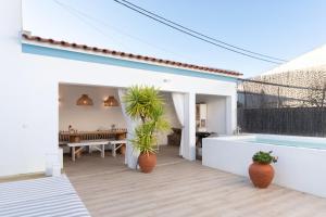 a white house with a tub and a patio at Casa da Avó Pam in Alcáçovas
