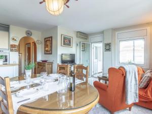 a dining room with a table and chairs and a kitchen at Apartment Sol i Canal by Interhome in Empuriabrava +22 photos