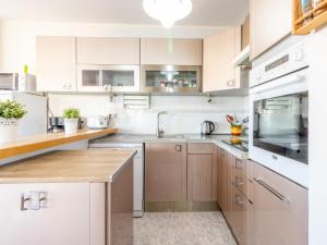 a kitchen with white cabinets and stainless steel appliances at Apartment Sol i Canal by Interhome in Empuriabrava