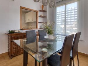 a dining room with a glass table and chairs at Apartment Mare Nostrum-1 by Interhome in Calpe +17 photos