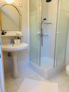 a bathroom with a shower and a sink at Villa B96 Siófok in Siófok