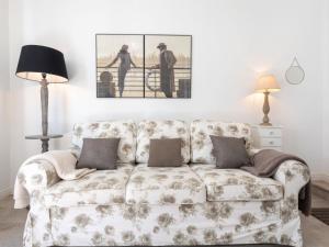 a couch in a living room with a picture on the wall at Apartment L'Abeille d'Or by Interhome in Carnac