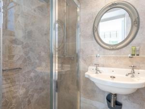 a bathroom with a sink and a shower at Apartment L'Abeille d'Or-1 by Interhome in Carnac