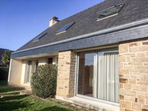 a house with a large window on the side of it at Holiday Home Grah Moullac by Interhome in Carnac