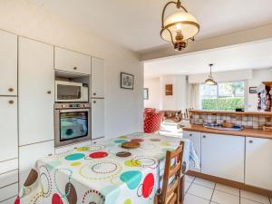 a kitchen with a table with a table cloth on it at Holiday Home Grah Moullac by Interhome in Carnac