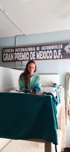 a girl sitting on a bed in a hospital room at Santander Central Hostel in Santander