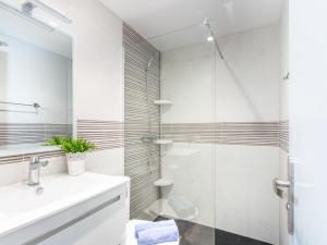 a white bathroom with a shower and a sink at Apartment Gran Reserva-31 by Interhome in Empuriabrava