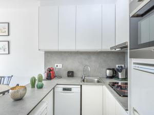 a kitchen with white cabinets and a sink at Apartment Pattaya-8 by Interhome in Empuriabrava +20 photos