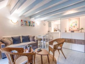 a living room with a couch and chairs and a table at Apartment Les Pins-3 by Interhome in Carnac