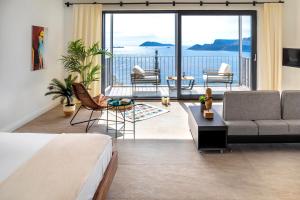 a living room with a bed and a view of the ocean at Born in Blue in Kaş