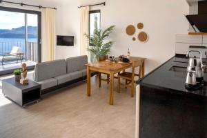a living room with a couch and a table at Born in Blue in Kaş