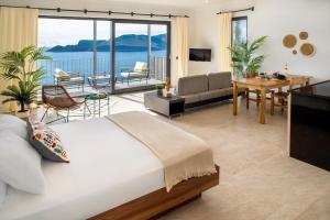 a bedroom with a bed and a living room at Born in Blue in Kaş